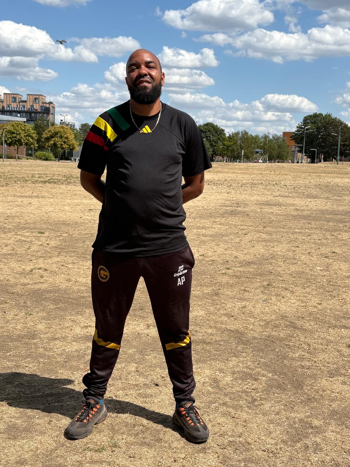 Lead coach smiling on the training field