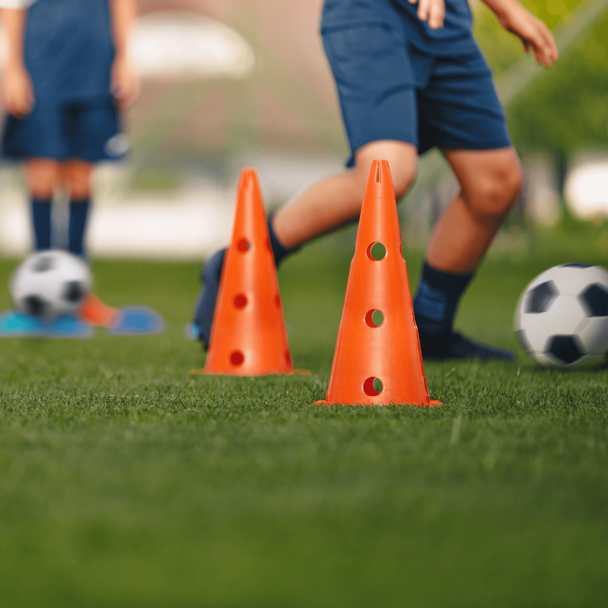 Child dribbling a football during a match